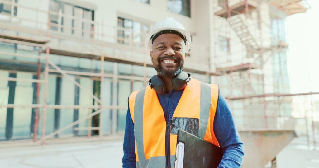 Smiling contractor with clipboard on job site